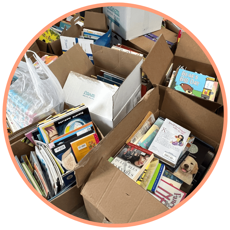 Photo of cardboard boxes full of books in a circular orange frame. 